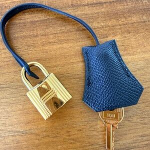 Hermes clochette gold padlock with key, black leather holder